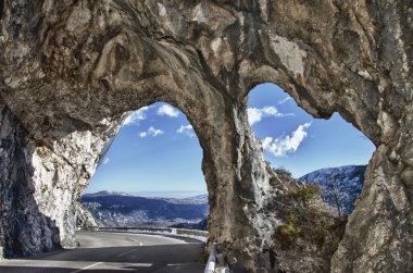 natural rock arches in provence mountain road clipart