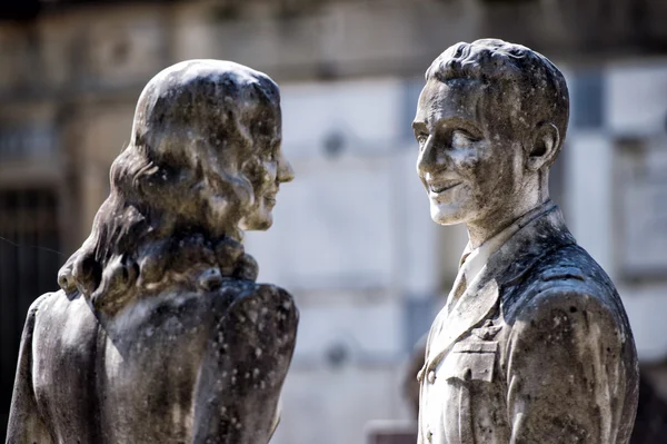 Junge Liebende bei lächelnder Marmorstatue — Stockfoto