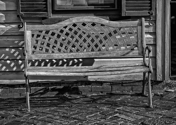 Isolated bench on wood in black and white — Stock Photo, Image