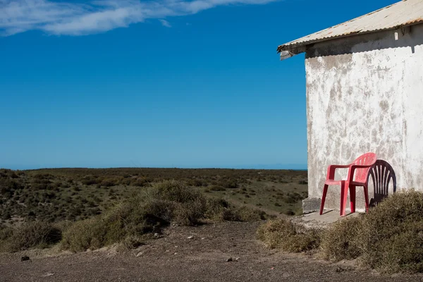 Chair outside patagonia lighthouse in valdes peninsula — Stock Photo, Image