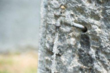 water falling from open tap fountain