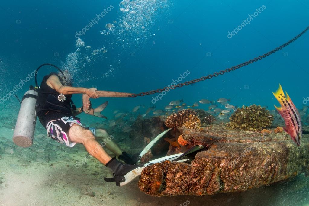Diver holding boat anchor from underwater — Stock Photo © izanbar