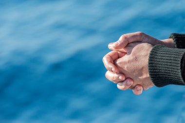 Sailor hands on blue sea background clipart