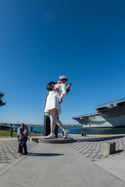 SAN DIEGO, USA - NOVEMBER 14, 2015 - People taking a selfie at sailor and nurse while kissing statue san diego clipart
