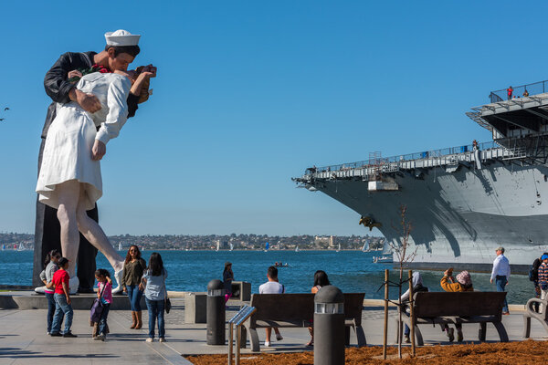 SAN DIEGO, USA - NOVEMBER 14, 2015 - People taking a selfie at sailor and nurse while kissing statue san diego