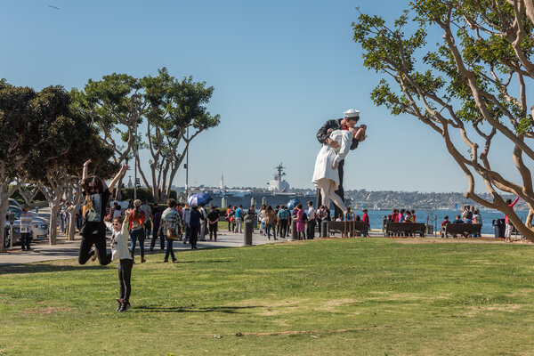 SAN DIEGO, USA - NOVEMBER 14, 2015 - People taking a selfie at sailor and nurse while kissing statue san diego