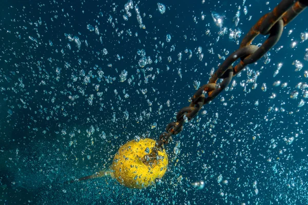 Bolhas de mergulhador perto de corda de barco subaquática — Fotografia de Stock