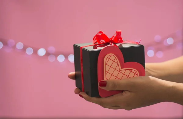 Detail of female hands with a gift box, for holidays such as Valentine\'s Day, birthday or Christmas.  2