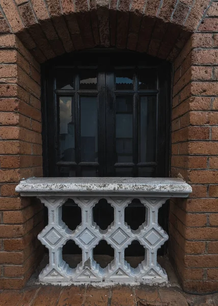 Traditional windows of the Mexican towns, vintage style made from roho partition, blacksmith and stone