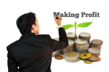 Beyaz arka plan üzerinde izole Filiz büyüyen ile sikke yığını üzerinde kar yapma yazma iş adamı arkasından,