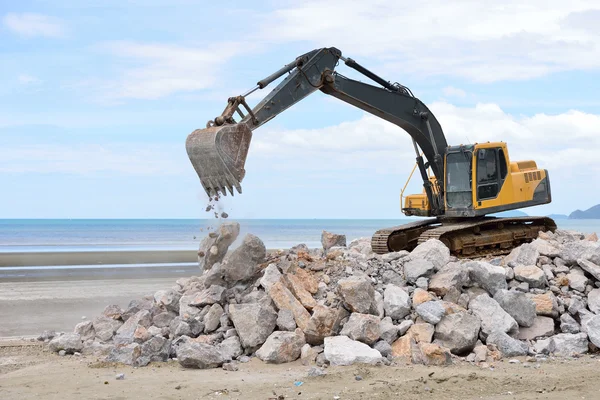Excavator machine moves with raised bucket