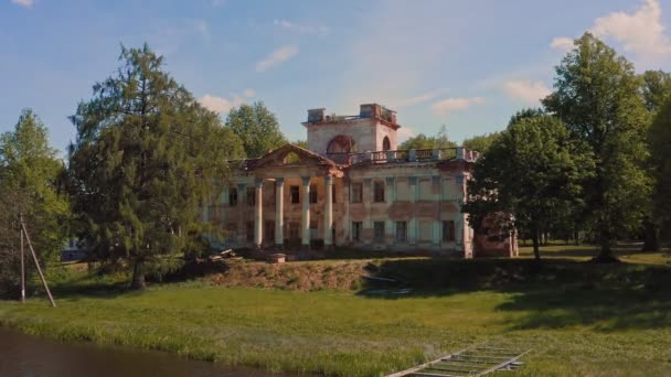 Herregård i Zhemyslavl, Belarus. Forladt palads, herregård eller palæ hus, med knuste vinduer. Gamle øde palads i en tæt grøn skov. – Stock-video