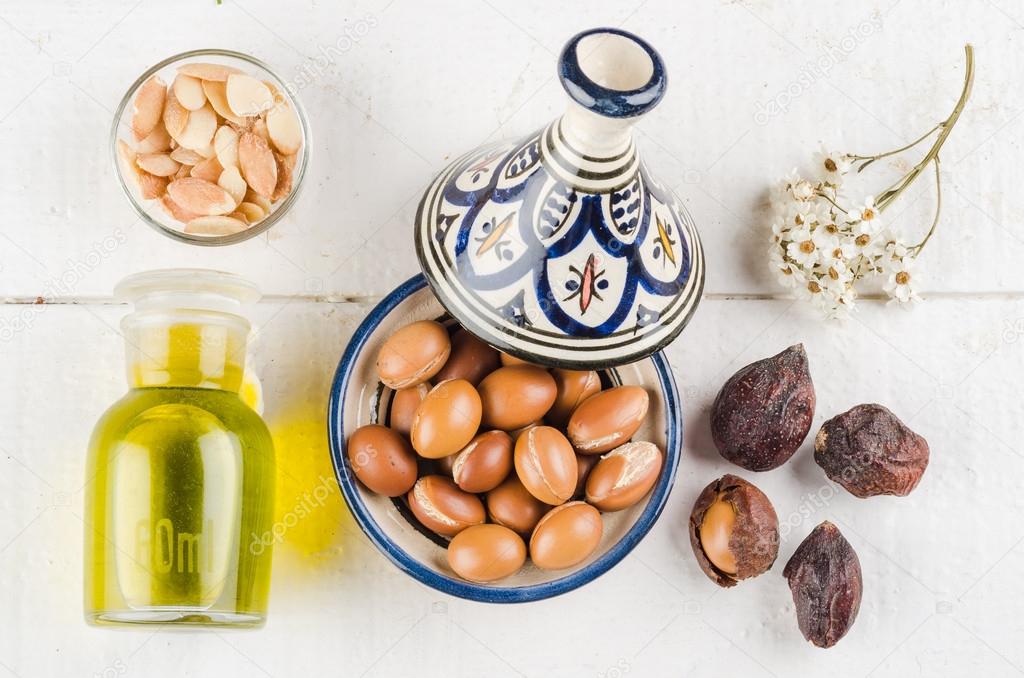 Argan nuts and oil on tabletop