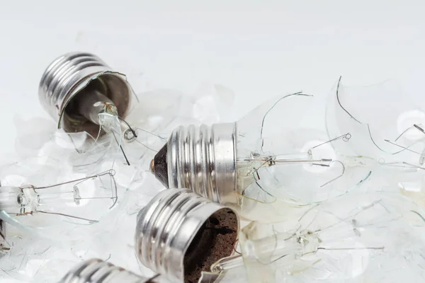 Broken incandescent light bulbs on a white background. Crash the light bulb for the chandelier close-up. Vintage Old Incandescent light bulbs