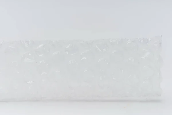 Bubble wrap on a white background close-up. Film for packaging of fragile goods and objects