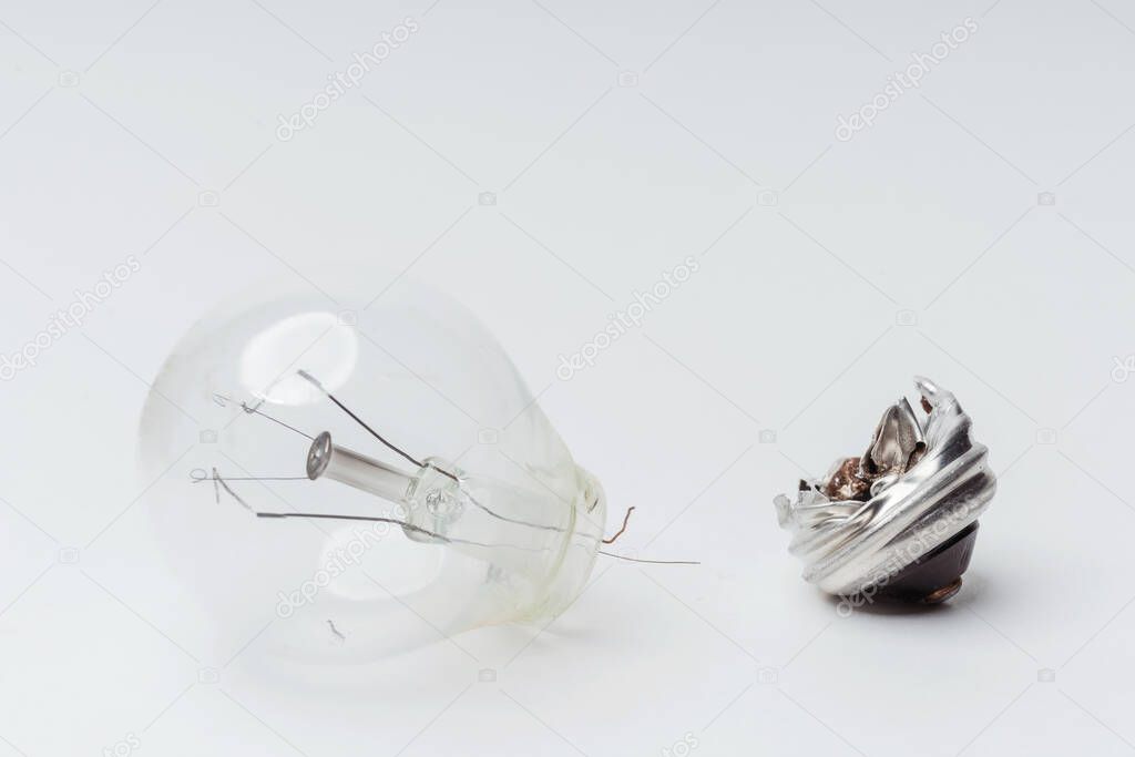 Burnt-out incandescent light bulbs on a white background. Broken light bulbs for a chandelier close-up. Vintage old outdated Incandescent light bulbs