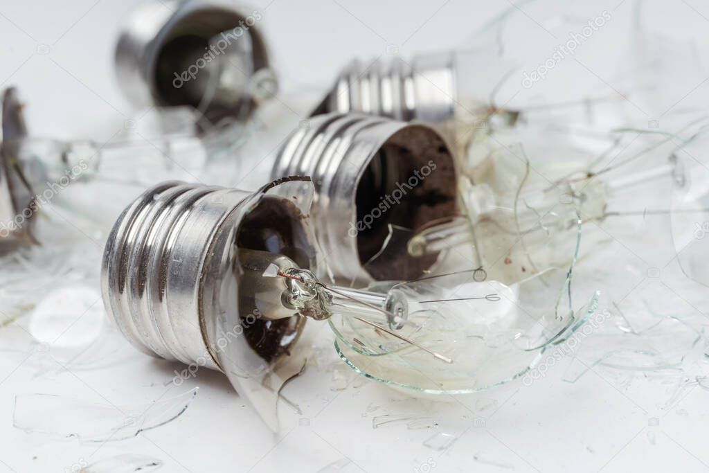 Broken incandescent light bulbs on a white background. Crash the light bulb for the chandelier close-up. Vintage Old Incandescent light bulbs
