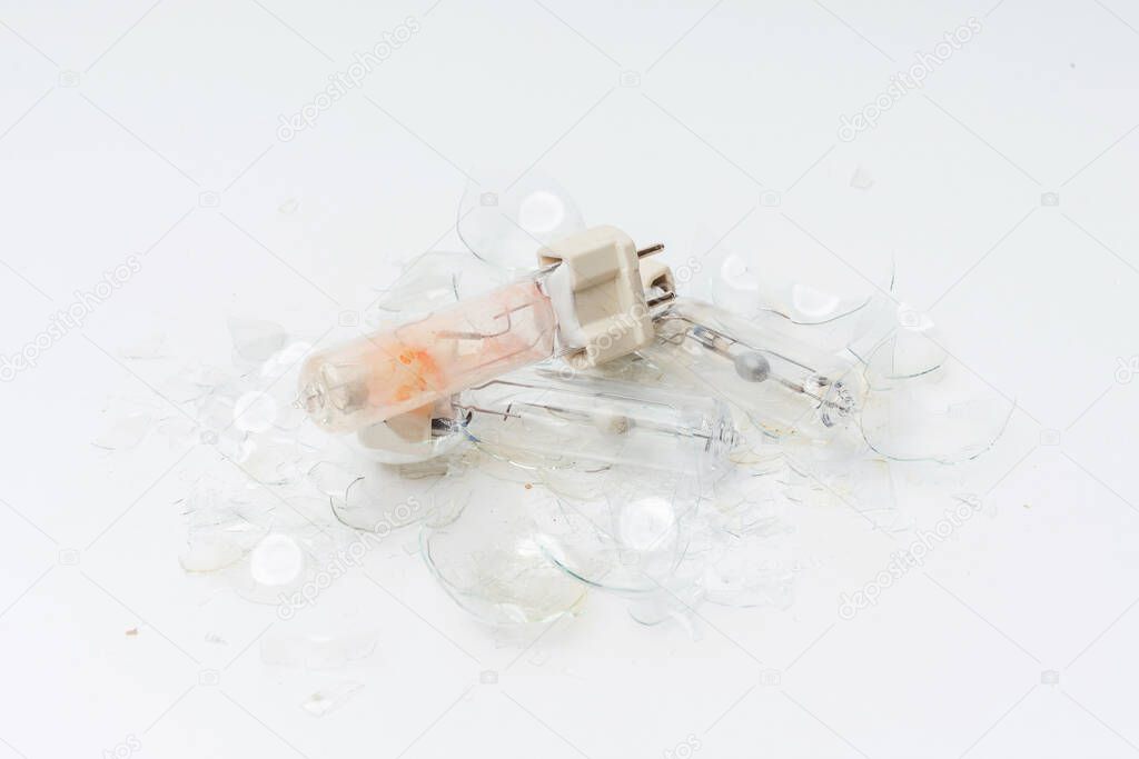 Broken light bulbs on a white background. Burned out broken light bulbs. Details of the crash light bulb for the spotlight close-up