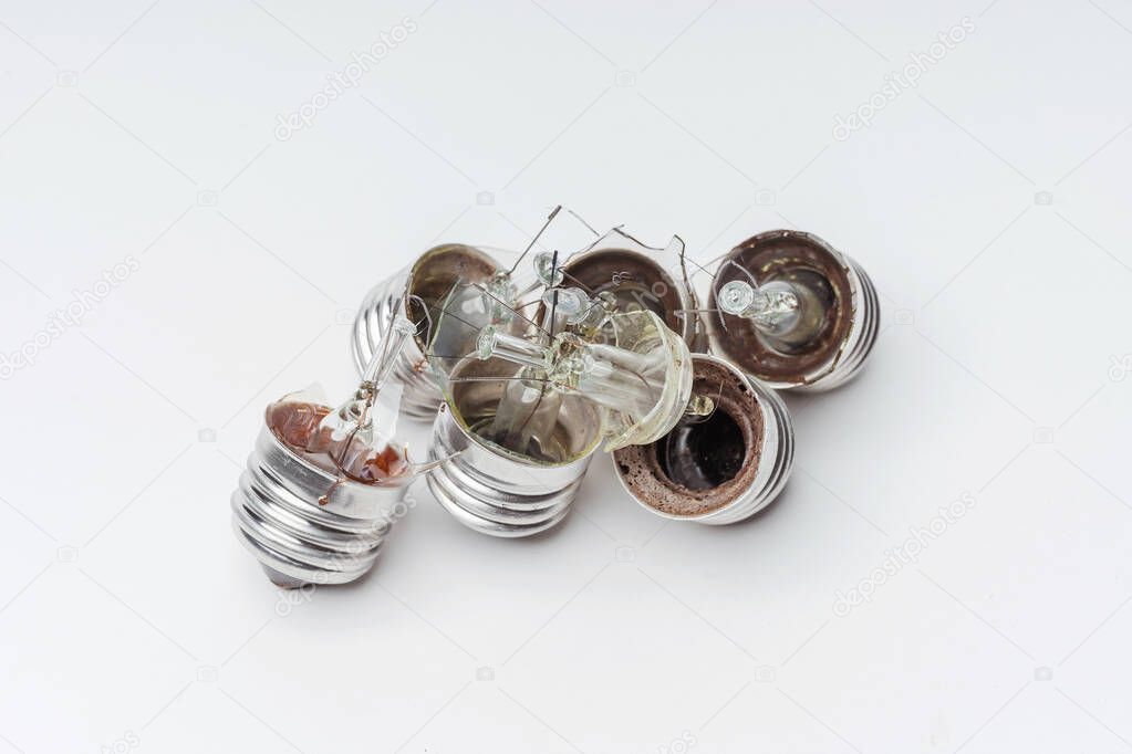 Broken incandescent light bulbs on a white background. Crash the light bulb for the chandelier close-up. Vintage Old Incandescent light bulbs