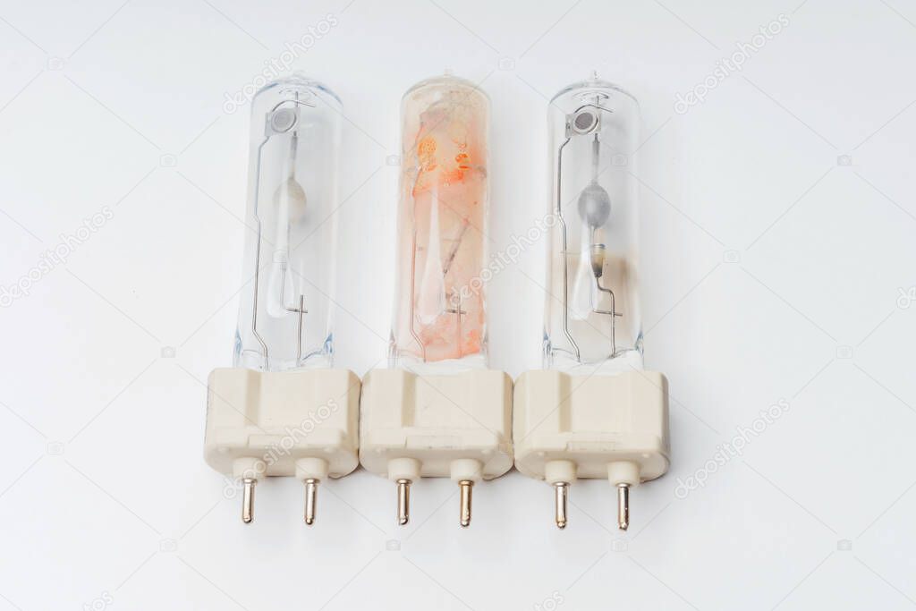 Halogen lamp on a white background. Burned out broken light bulbs. Details of the halogen light bulb close-up