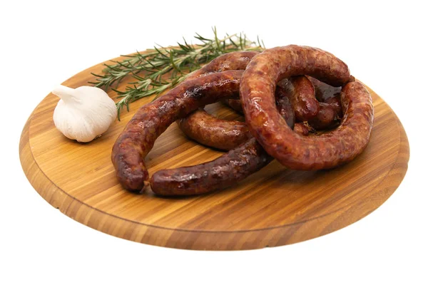 Saucisse de cumberland enroulée avec planche rustique à l'ail Photo De Stock