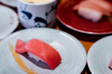 Suşi ve Sashimi. Suşi ve Sashimi tabakları taşıma bandında yuvarlanıyor..