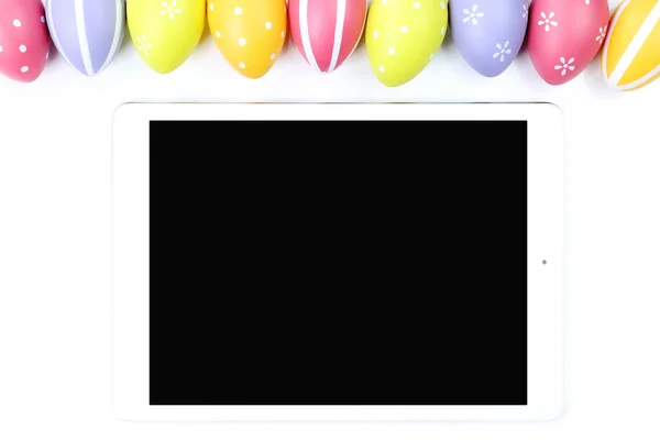 Colorful Easter eggs with tablet — Stock Photo, Image