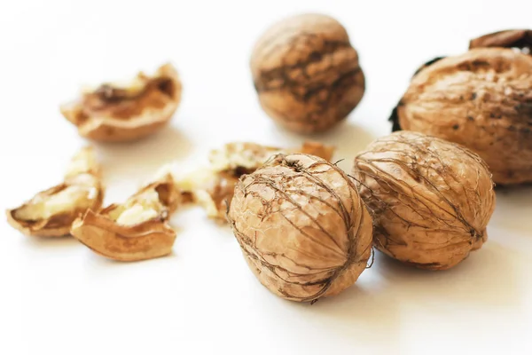 Walnut crushed and full nuts on white background — Stock Photo, Image