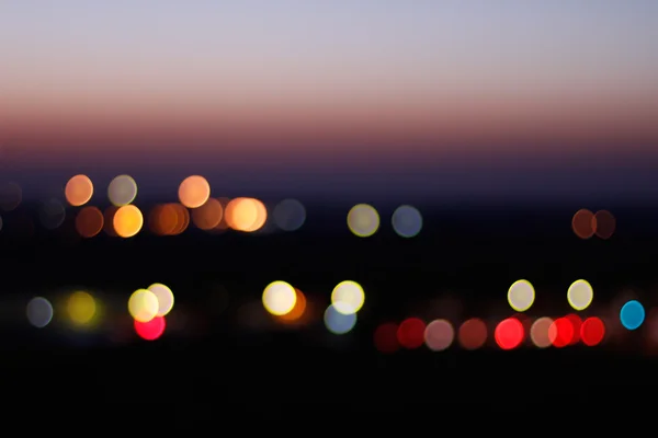 Muticolour bokeh of the city at sunset — Stock Photo, Image