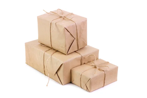 Three packages packed in kraft paper — Stock Photo, Image