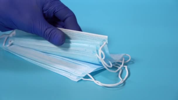 Лікарі залишають нові захисні маски на синьому фоні лікарні Коронавіруса — стокове відео
