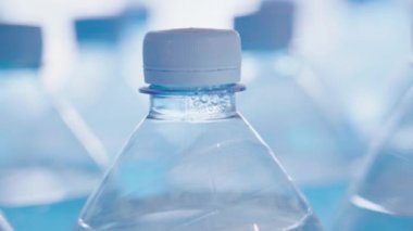 Drinking water in plastic bottles. Close-up.