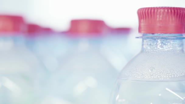 Drinking water in plastic bottles. Close-up. — Stok video