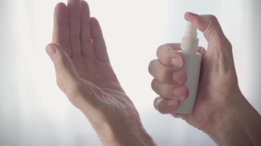 Old Mans Hands Use Hand Sanitizer Spray. Measures to Prevent Spread of Virus