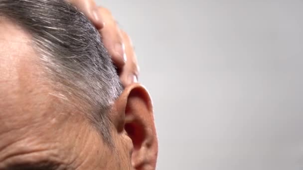 Γκρίζα μαλλιά που υψώνονται στο κεφάλι ενός μεσήλικα άντρα. — Αρχείο Βίντεο