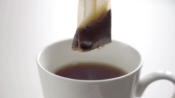 Taza de té negro aislado en blanco — Vídeo de stock