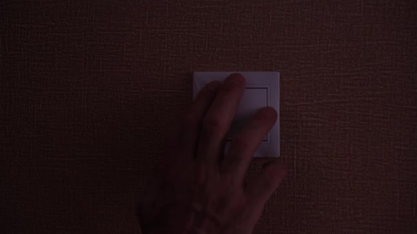 Hand Elderly Man Turns off and On the Light from the Wall Switch — Stock Video
