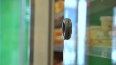 Alışveriş Arabası Gelen ve Raftan bir paket sosis almak için Dükkandaki Buzdolabını Açıyor. Alıcı Market Dolaptan Yiyecek Seçiyor