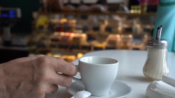 Stary człowiek pije kawę w kawiarni.. — Wideo stockowe