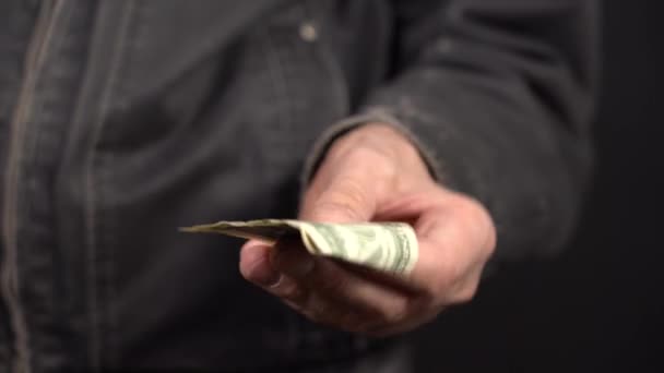 Close-up of a One Dollar in a Mans Hand in a Work Jacket. Put your Money in your Pocket — Stock Video