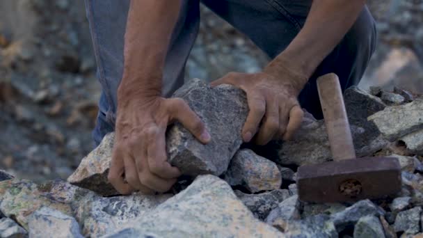 Slave hard work. Hard labor. The convicts hands are holding a hammer. Desire to be free. Desire to break the shackles — Stock Video