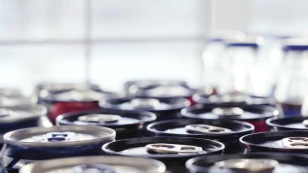 Un montón de latas de aluminio y botellas en la tienda junto a la ventana. Primer plano. — Vídeos de Stock