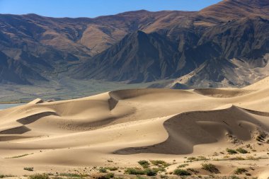 Sand dunes in the desert high on the Tibetan Plateau in the Tibet Autonomous Region of China. clipart