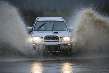 Driving on a flooded country road clipart