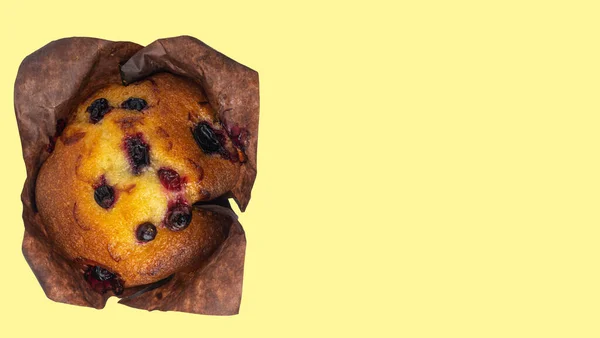 Cupcake com groselhas no fundo amarelo claro, espaço de cópia vista superior — Fotografia de Stock