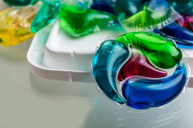 capsules with laundry gel and blurred background close up