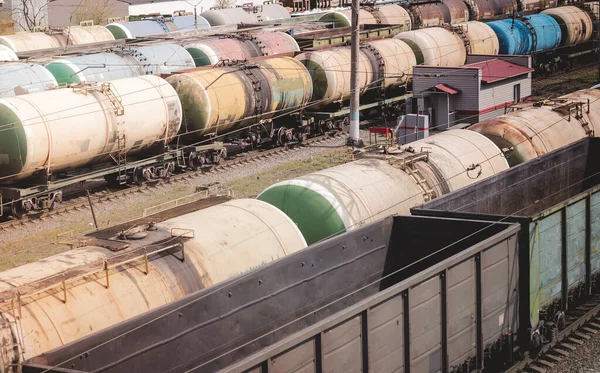 Wagons with goods on railroad. Heavy industry. Industrial landscape with train, railway platfform at sunset.