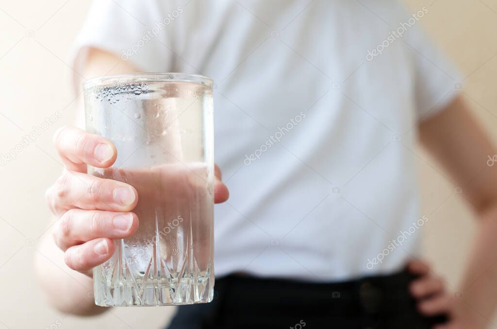 Close up A woman in casual clothes holds a glass of cold water