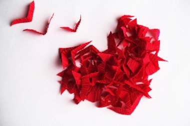 red heart made of paper on white background