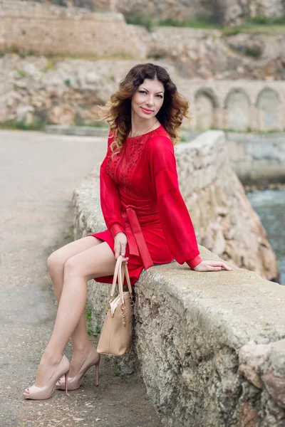 Young woman in a red dress posing — Stock Photo, Image